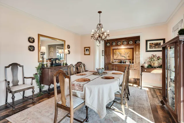 a view of a dining room with furniture and a chandelier