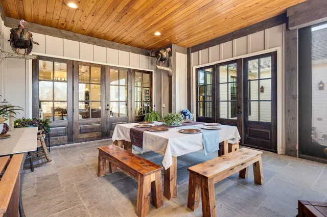 a living room with furniture a table and a large window