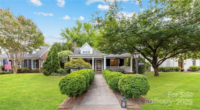 a front view of house with yard and green space
