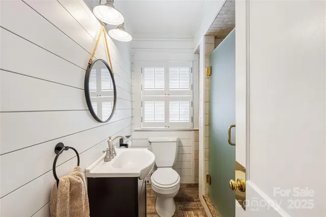 a bathroom with a sink a toilet and a mirror