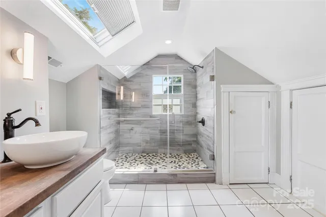 a spacious bedroom with a large bed and a dresser