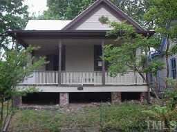 a view of house with backyard and sitting area