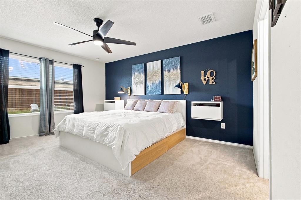 6609 Auburn Dl Road Pilot Point, TX 76258 - Photo 20 of 38 Plush carpet flooring, a dark accent wall, and a ceiling fan with integrated lighting