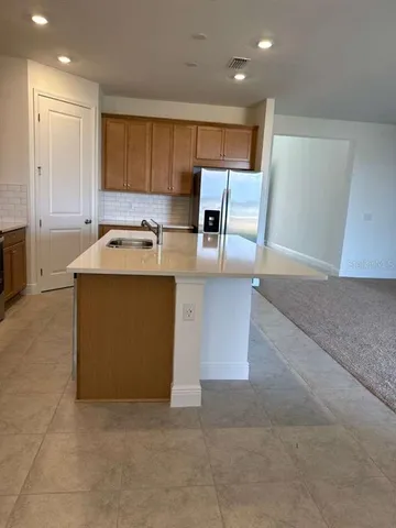 a kitchen with a refrigerator a microwave and cabinets