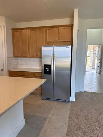 a kitchen with kitchen island a sink stove top oven and wooden cabinets