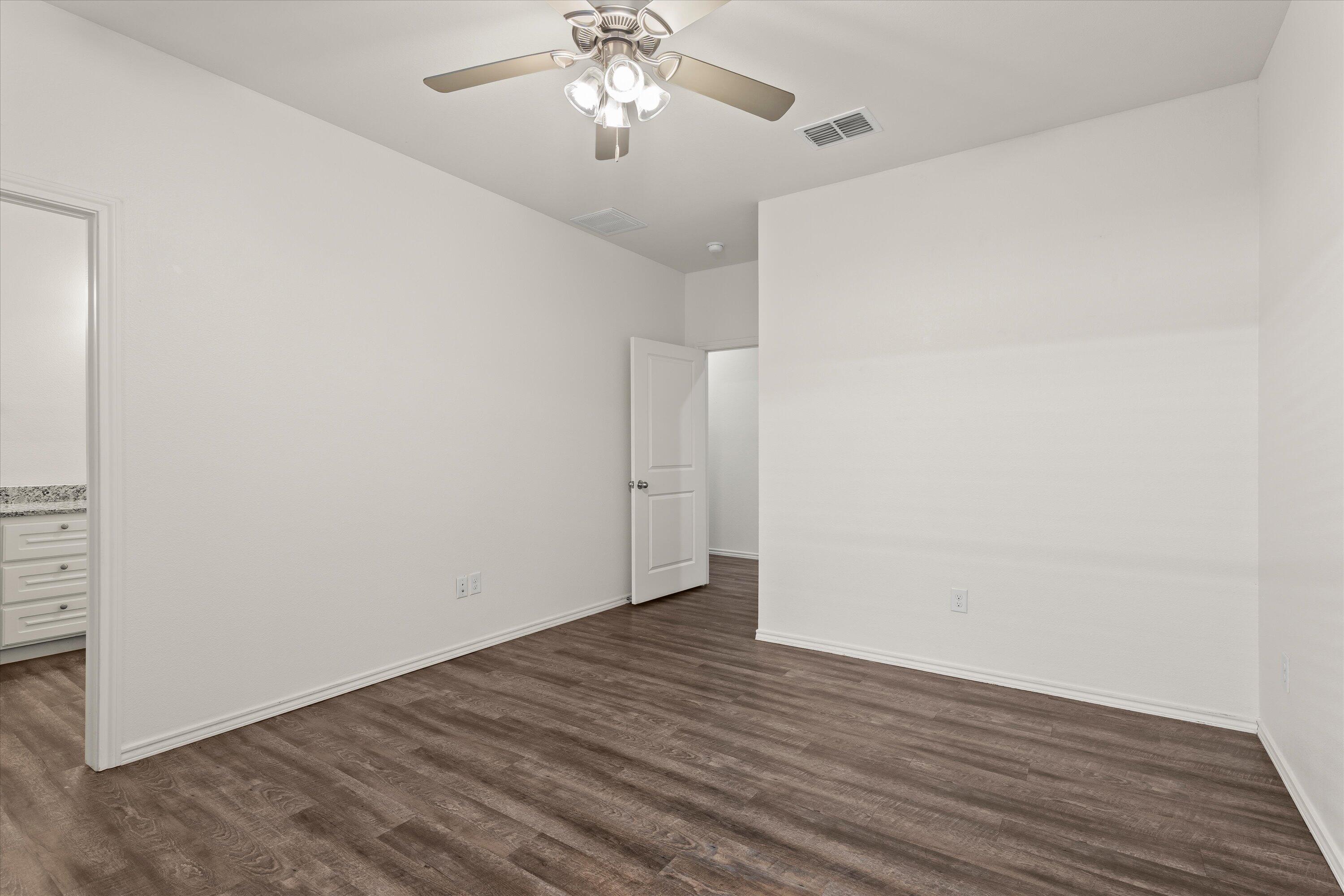 6908 21st Street Lubbock, TX 79407 - Photo 15 of 28 a view of an empty room with wooden floor