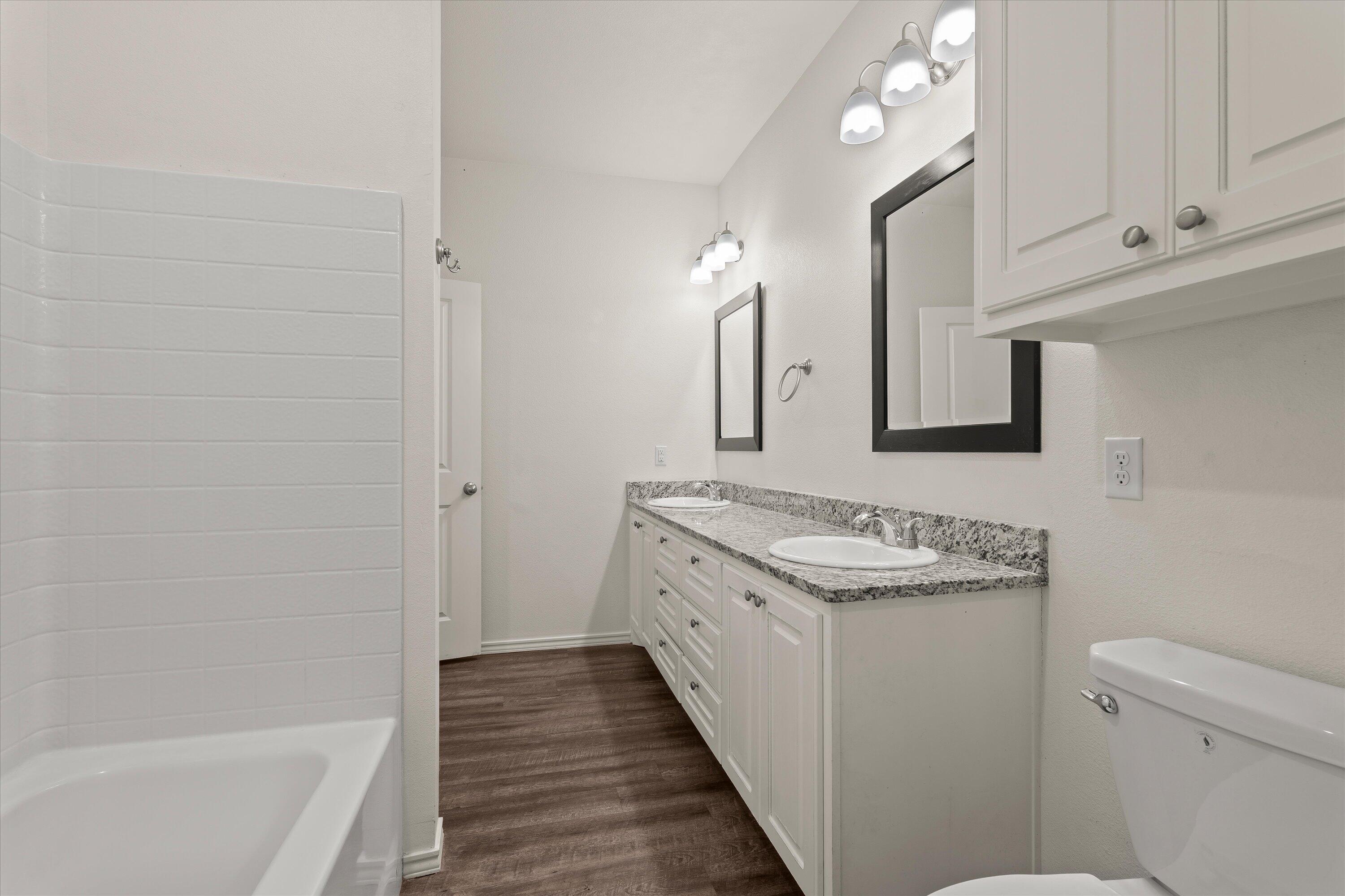 6908 21st Street Lubbock, TX 79407 - Photo 18 of 28 a bathroom with a sink a toilet and shower
