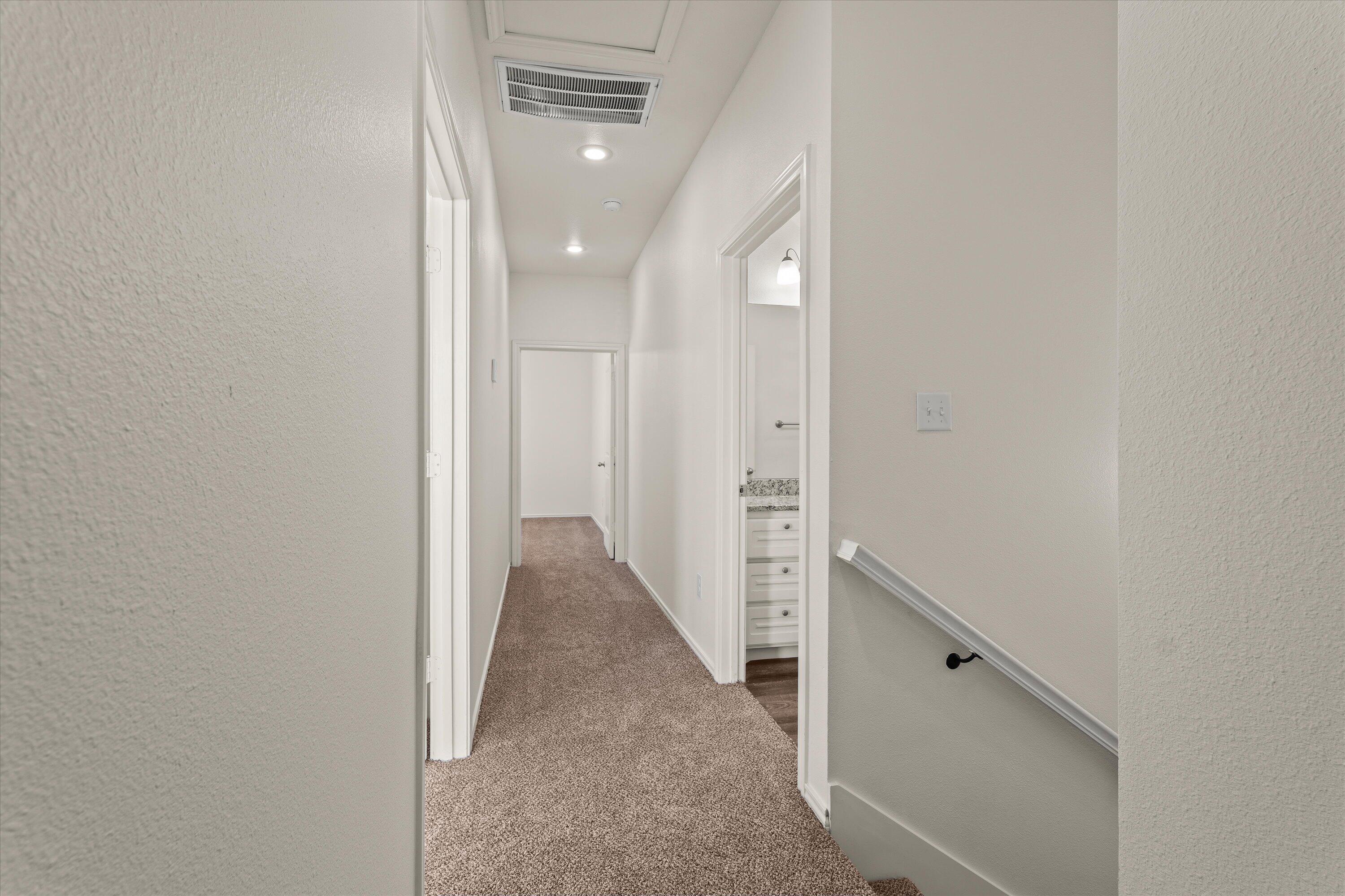 6908 21st Street Lubbock, TX 79407 - Photo 19 of 28 a view of a hallway with white walls