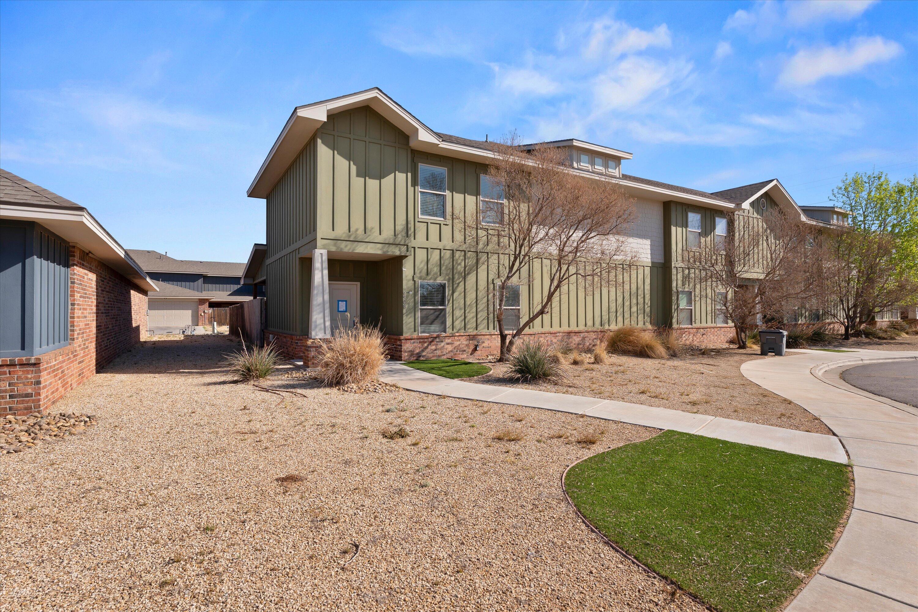 6908 21st Street Lubbock, TX 79407 - Photo 2 of 28 a front view of a house with a yard
