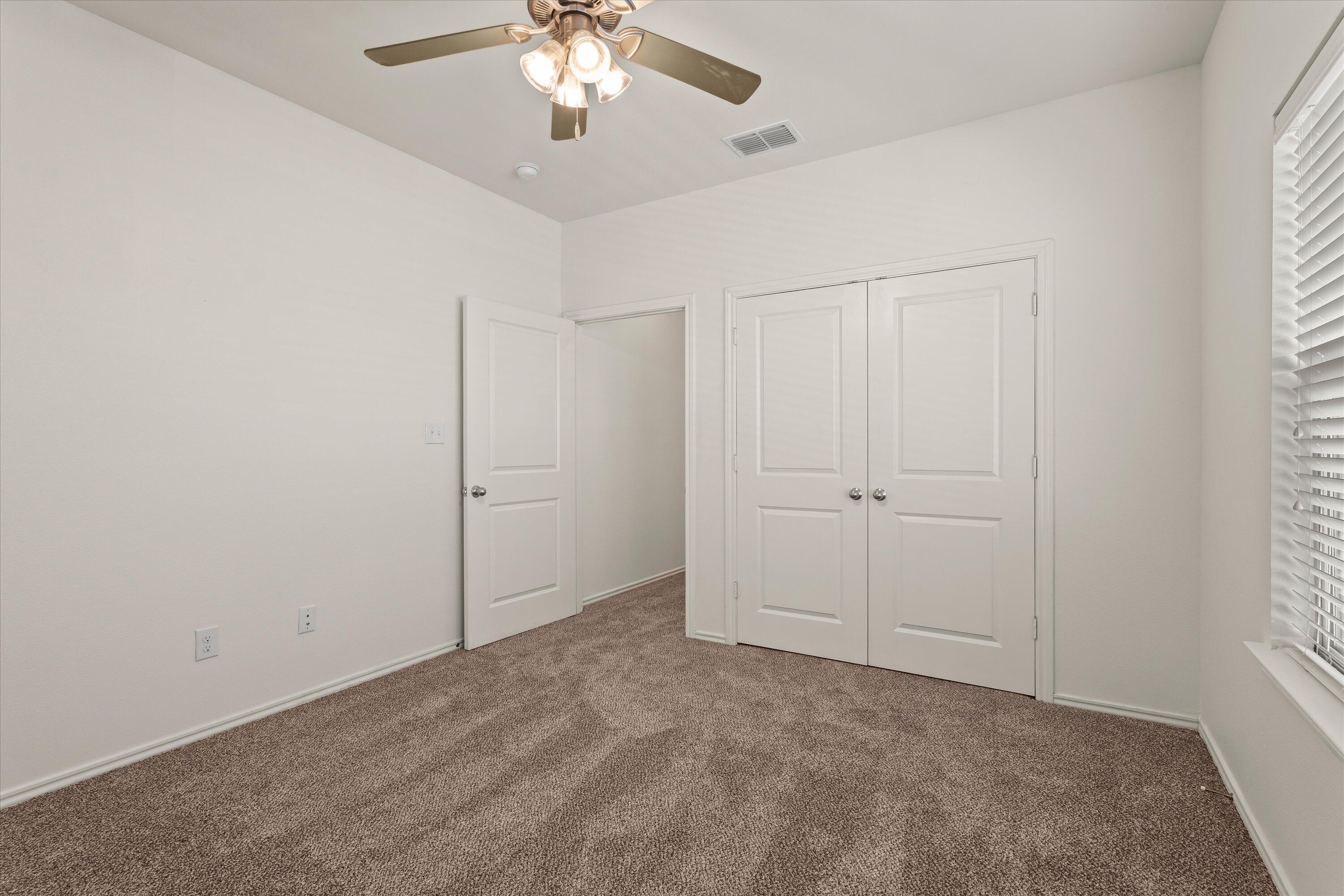 6908 21st Street Lubbock, TX 79407 - Photo 24 of 28 an empty room with chandelier fan