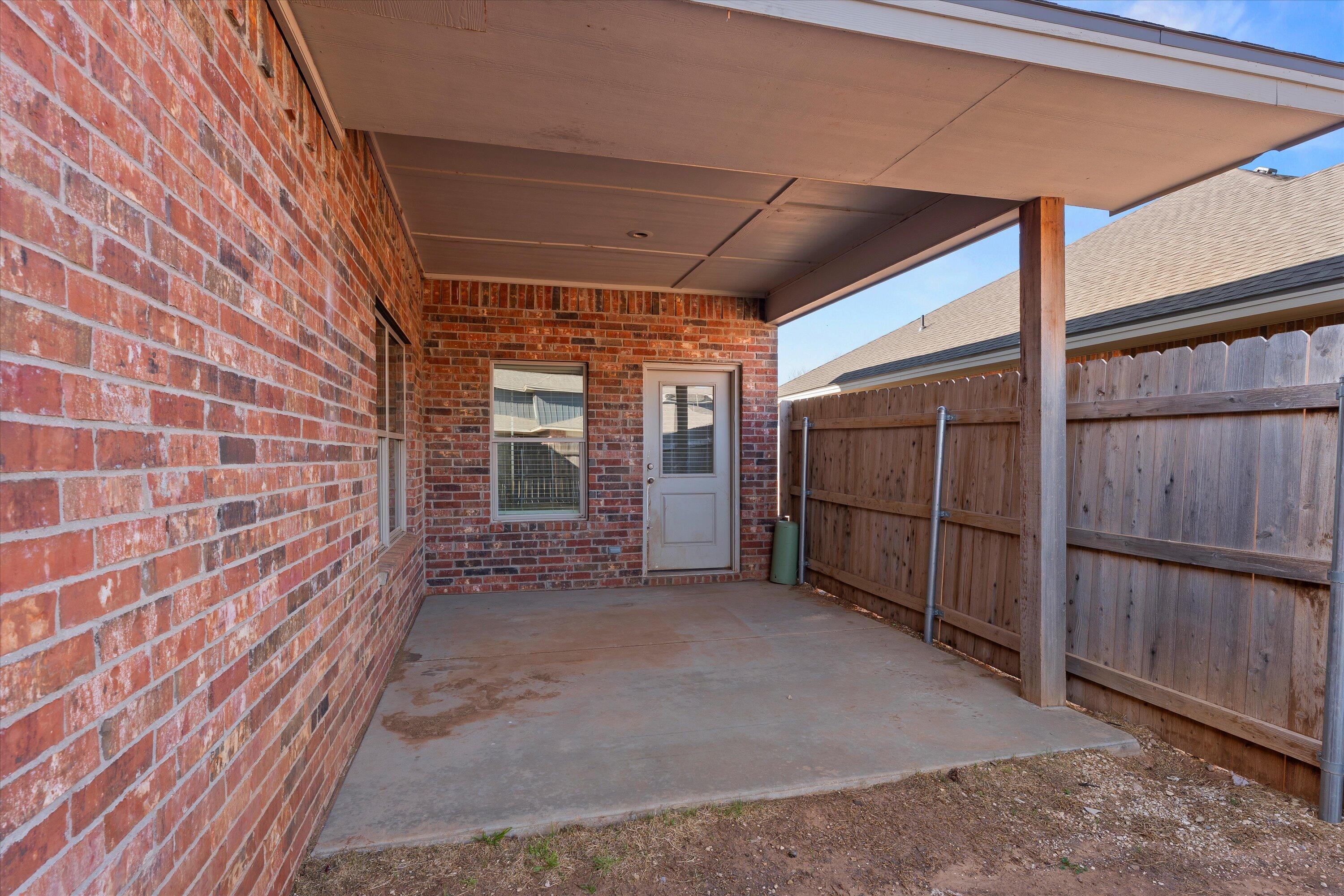 6908 21st Street Lubbock, TX 79407 - Photo 25 of 28 a view of backyard with wooden fence