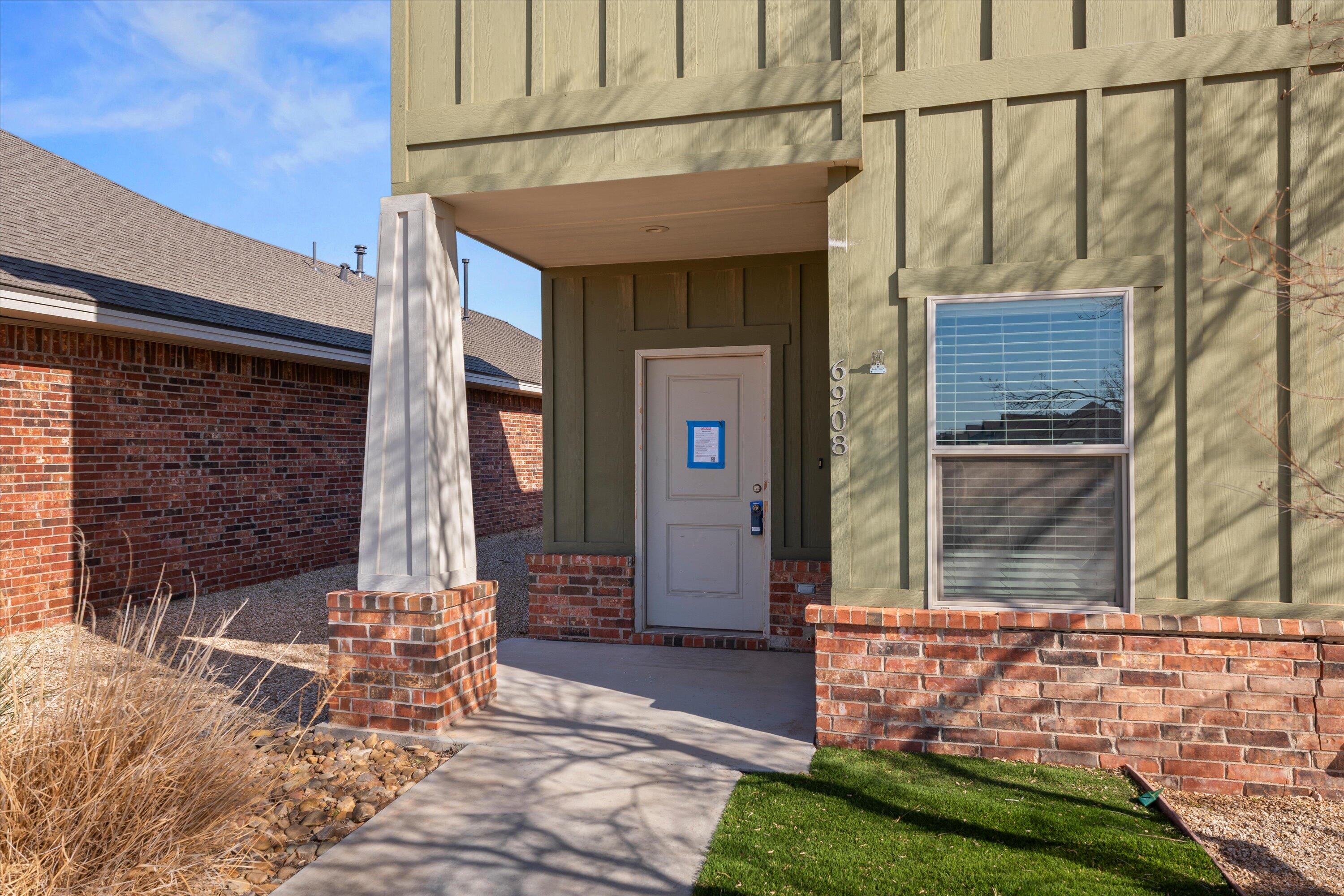 6908 21st Street Lubbock, TX 79407 - Photo 3 of 28 a front view of a house with a yard