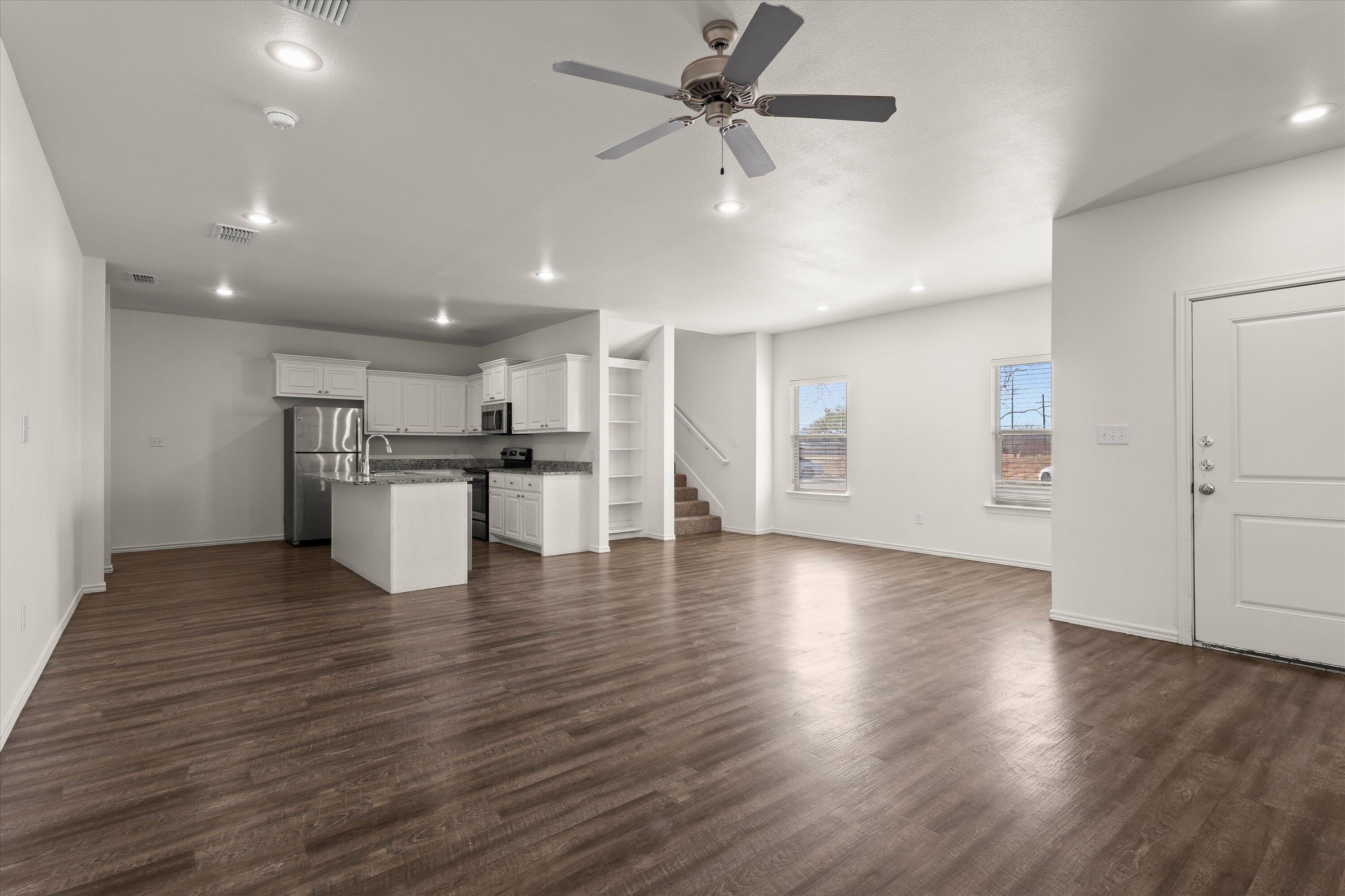 6908 21st Street Lubbock, TX 79407 - Photo 5 of 28 a view of a kitchen with a refrigerator and a stove top oven