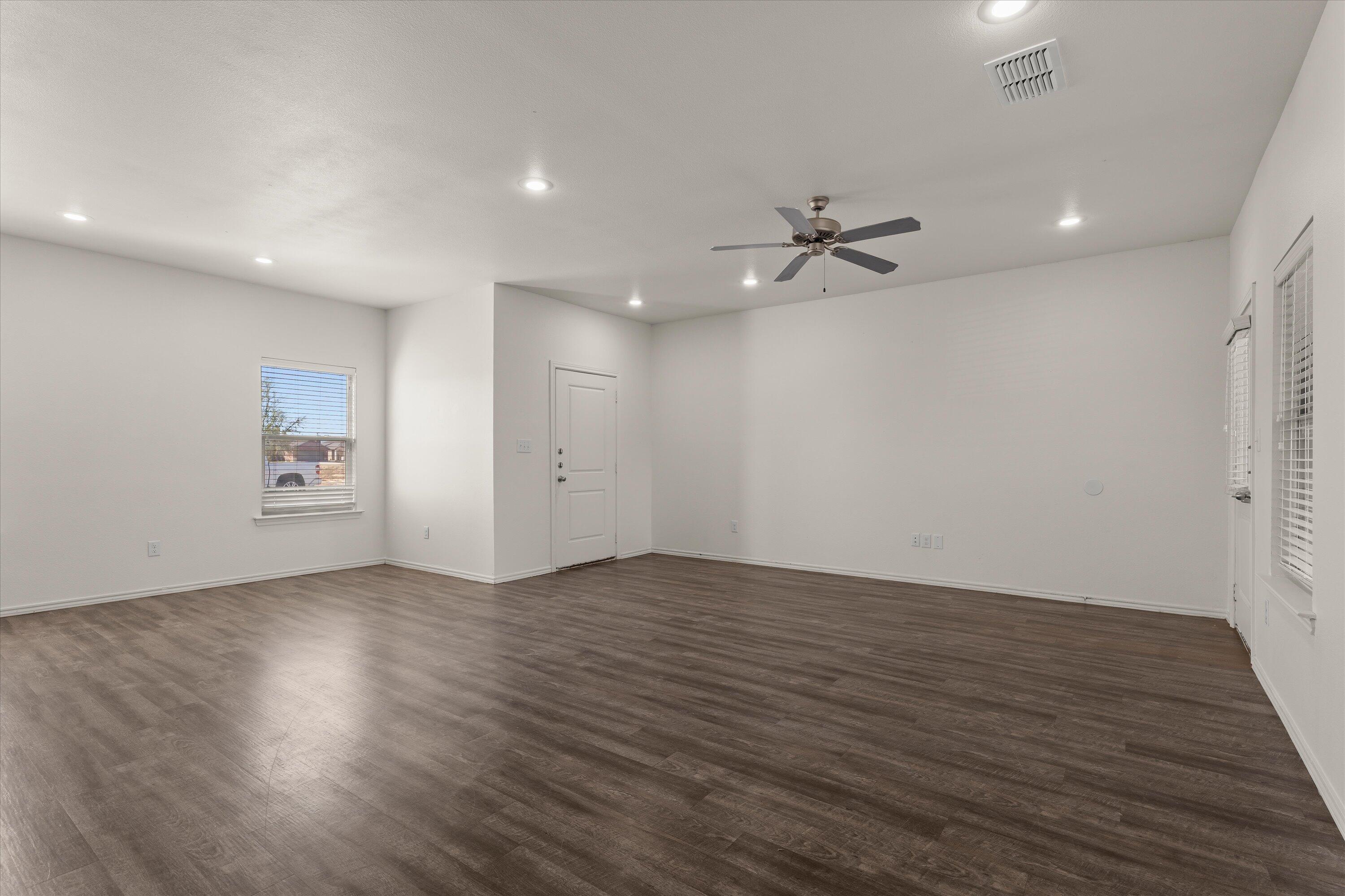 6908 21st Street Lubbock, TX 79407 - Photo 6 of 28 an empty room with fan and a ceiling fan