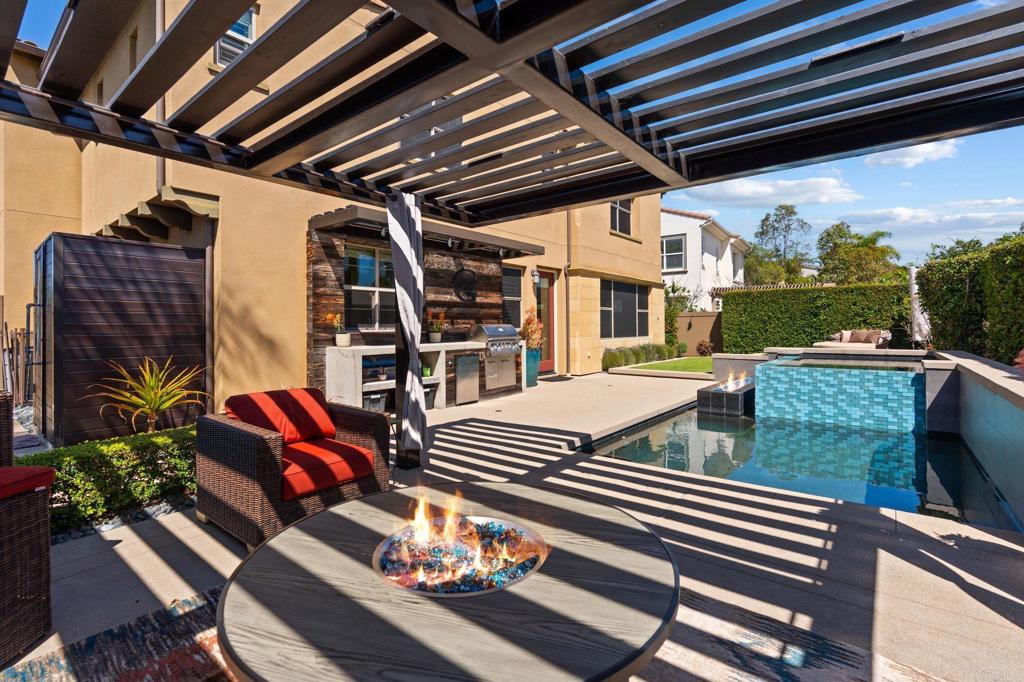 809 Dolphin Circle Encinitas, CA 92024 - Photo 56 of 71 a view of a patio with table and chairs with wooden floor and fence