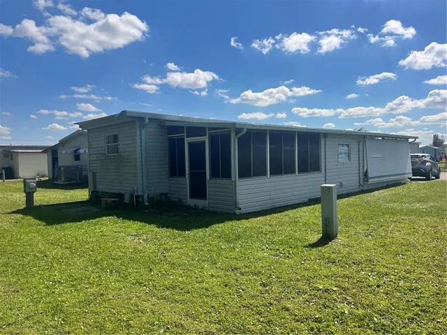 a view of a house with swimming pool and a yard