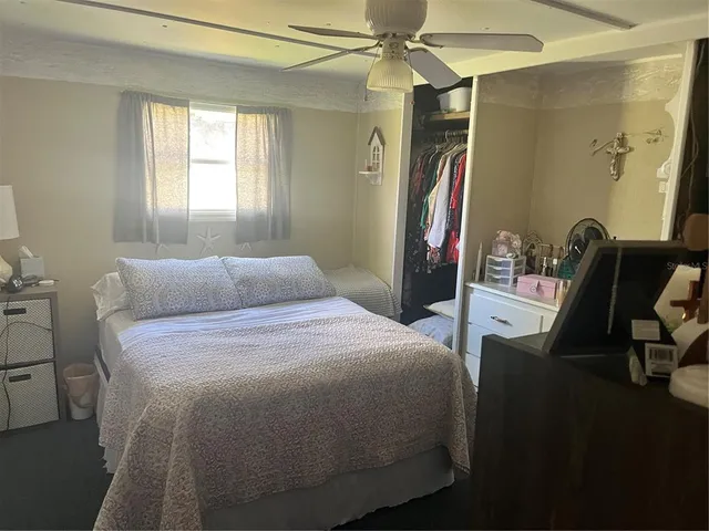 a bedroom with a bed and a mirror