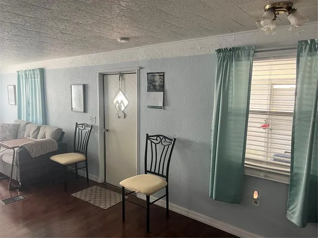 a view of a livingroom with furniture and a window