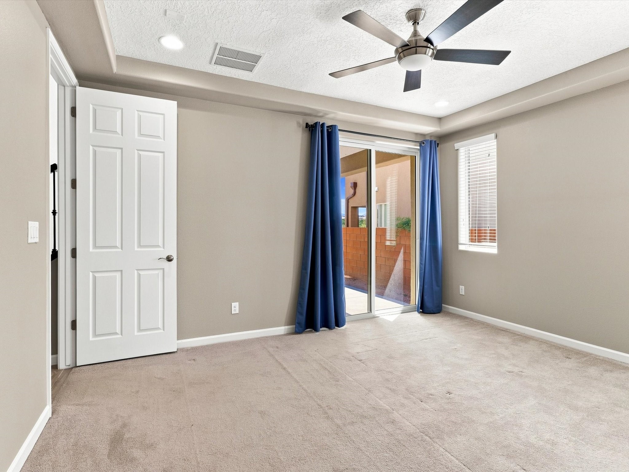 4642 Rail Runner Road Santa Fe, NM 87507 - Photo 21 of 74 Step from the primary bedroom onto the covered patio through a convenient sliding glass door.