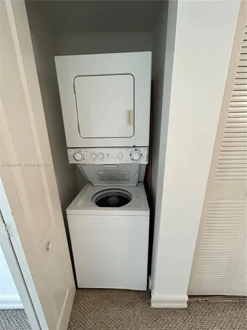 a bathroom with a granite countertop sink a toilet and a mirror