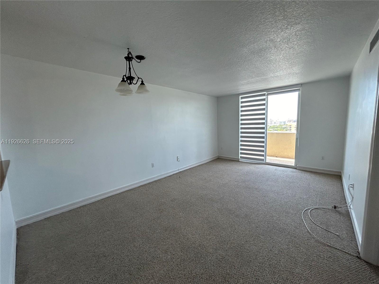 117 Northwest 42nd Avenue, Unit 1516 Miami, FL 33126 - Photo 31 of 76 an empty room with windows and chandelier fan