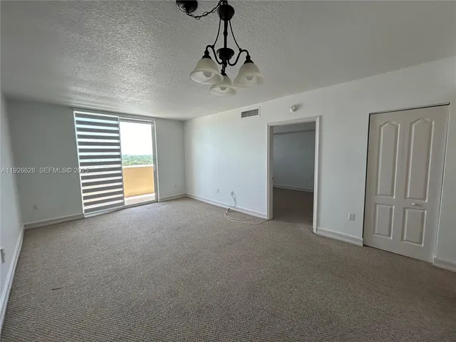 a view of kitchen with refrigerator microwave and stove