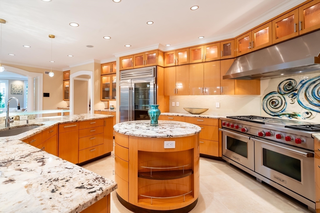 16 Meriam Street Lexington, MA 02420 - Photo 11 of 42 a kitchen with stainless steel appliances granite countertop a stove and a sink