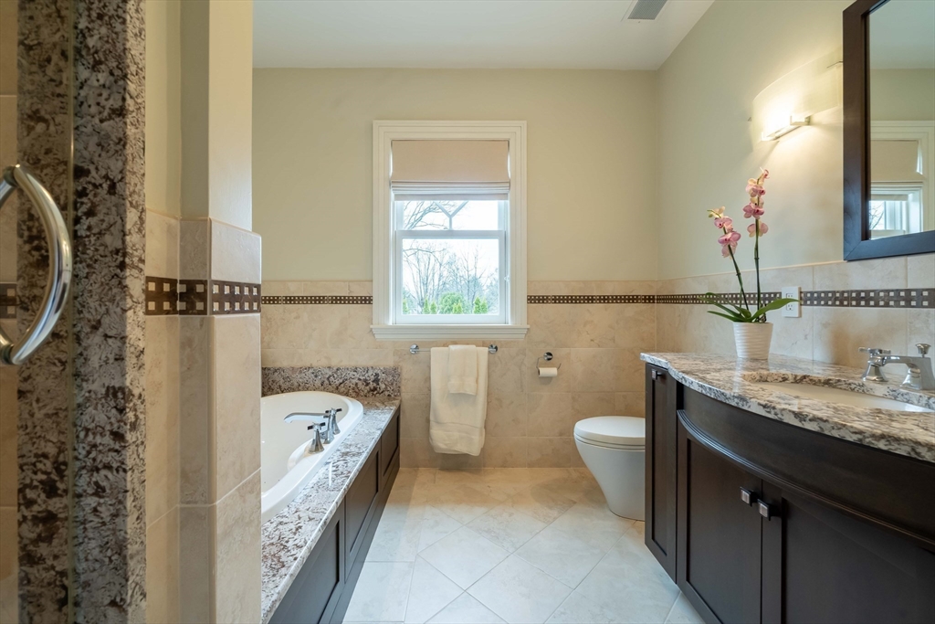 16 Meriam Street Lexington, MA 02420 - Photo 29 of 42 a bathroom with a granite countertop sink and a mirror