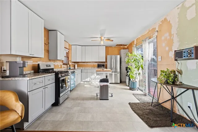 a kitchen with counter top space cabinets and stainless steel appliances