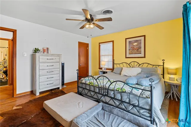 a bedroom with a bed and a dresser