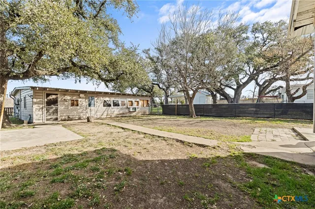 a view of yard with swimming pool and trees