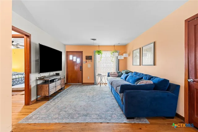 a living room with furniture and a flat screen tv