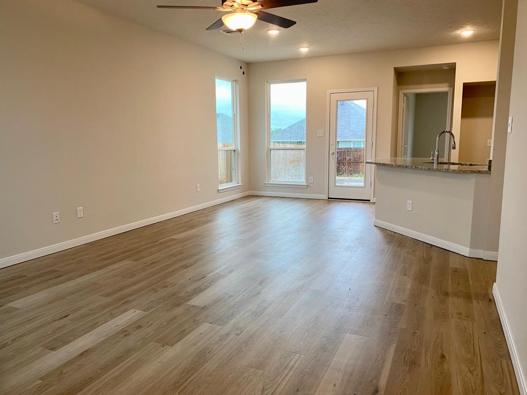 311 Camp Bowie Road Caldwell, TX 77836 - Photo 3 of 6 a view of an empty room with glass door and wooden floor
