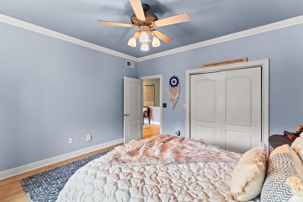 1276 Old Fall River Road Dartmouth, MA 02747 - Photo 31 of 42 a bedroom with a bed and a chandelier