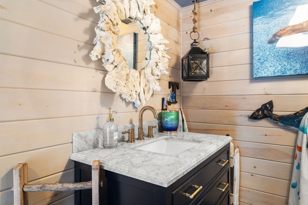 1276 Old Fall River Road Dartmouth, MA 02747 - Photo 37 of 42 a kitchen with a sink a vanity and a potted plant
