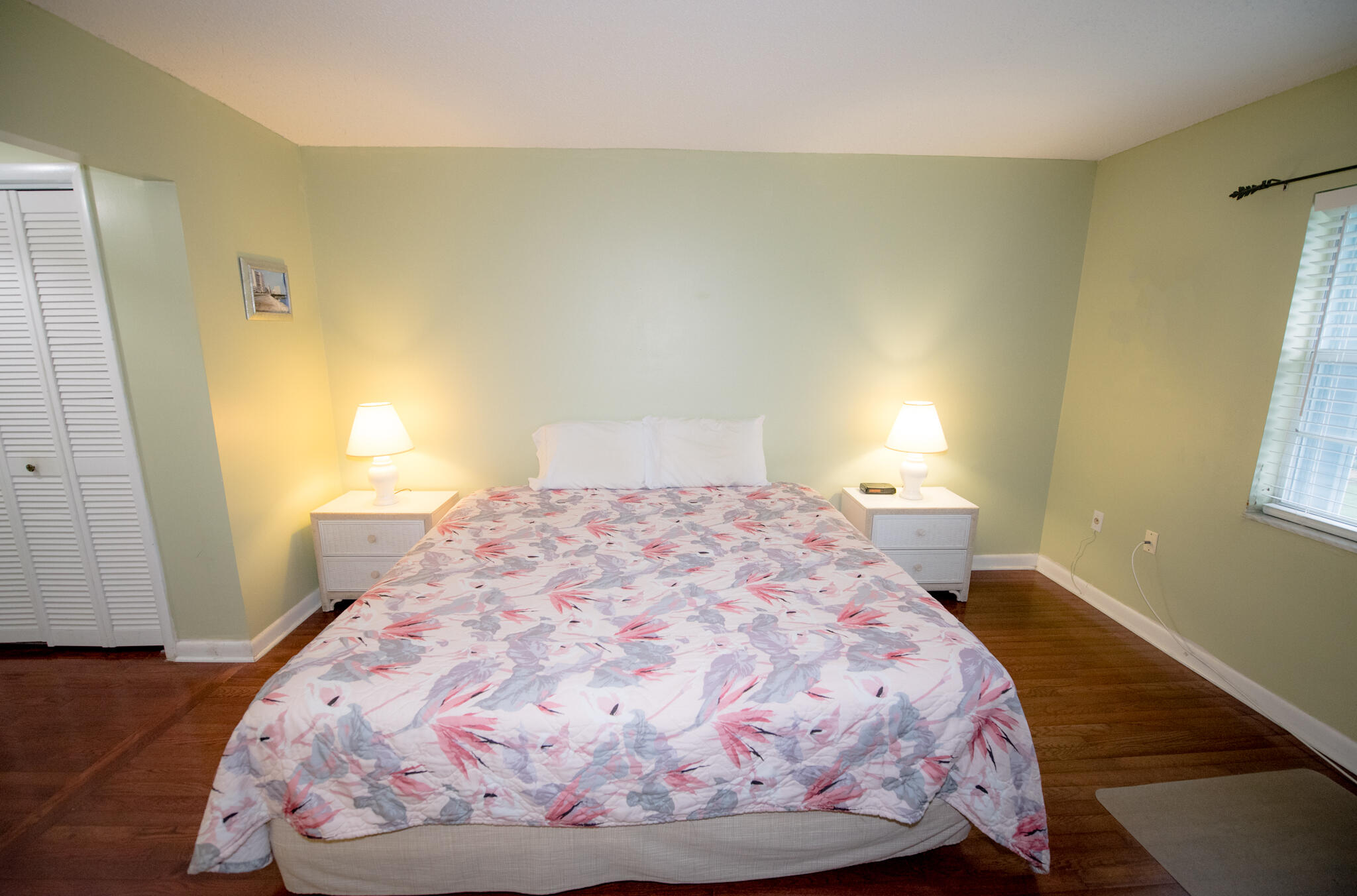 40 High Point Road, Unit F205 Tavernier, FL 33070 - Photo 12 of 14 a bedroom with a bed and wooden floor