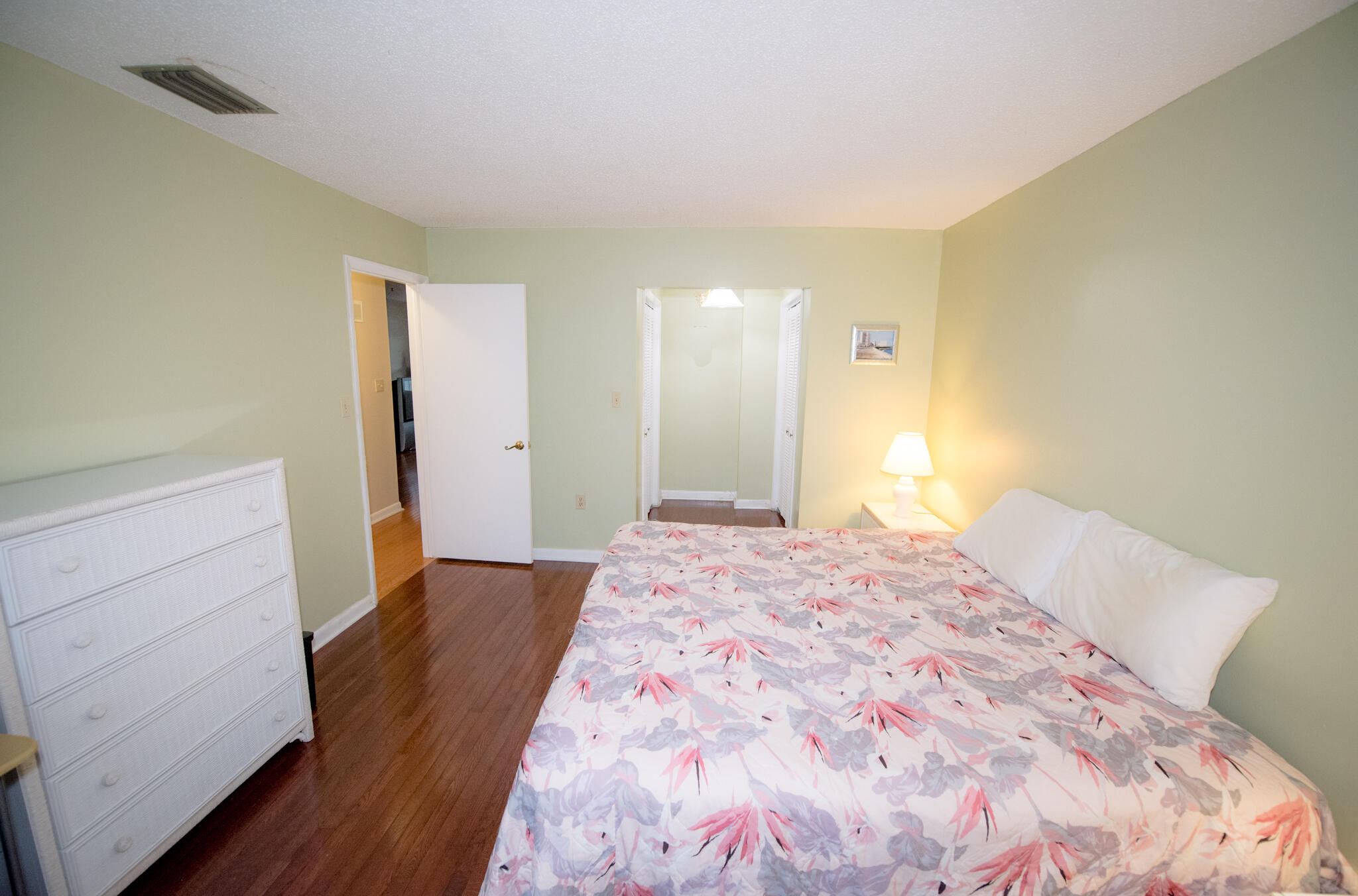 40 High Point Road, Unit F205 Tavernier, FL 33070 - Photo 13 of 14 a bedroom with a bed and wooden floor