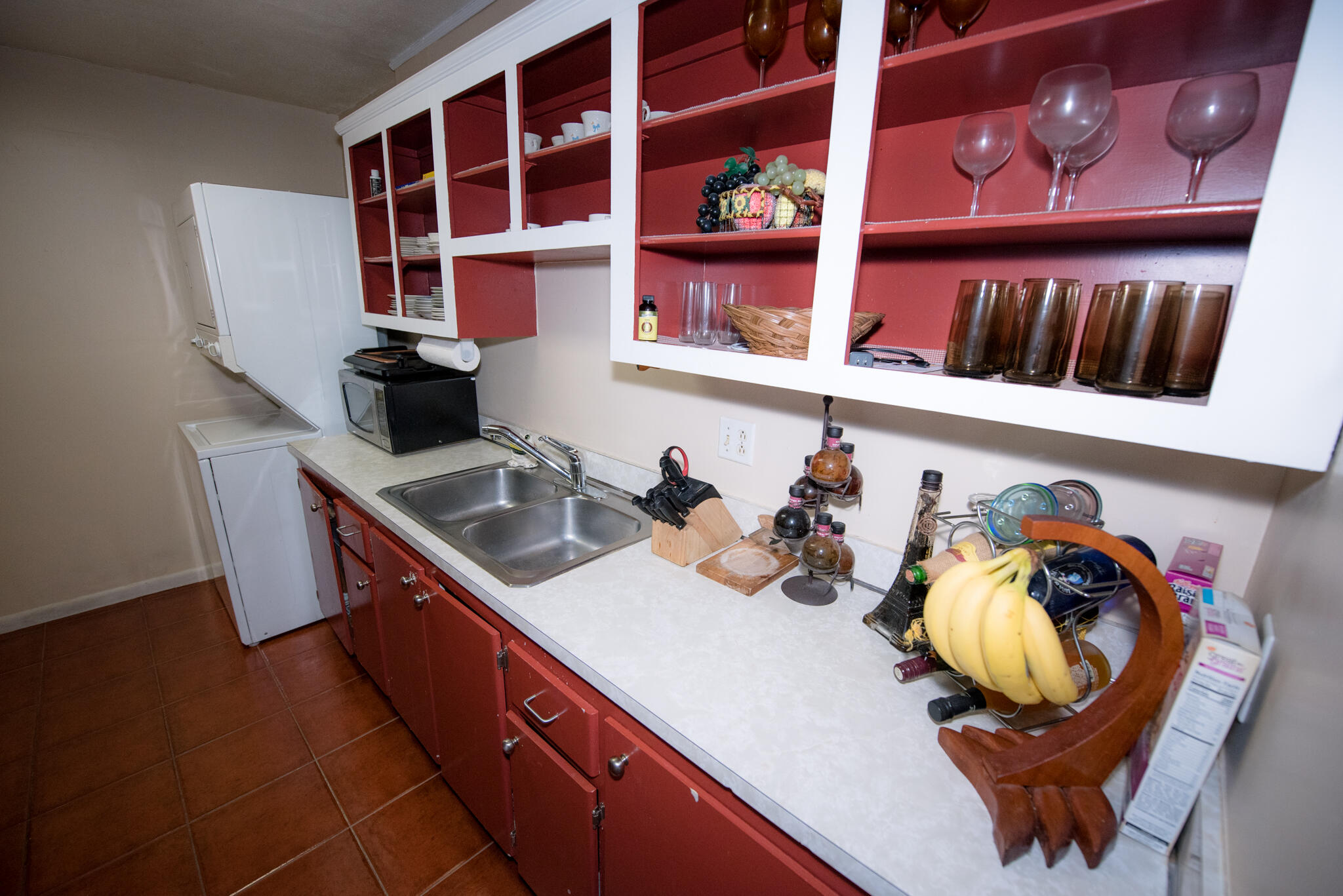40 High Point Road, Unit F205 Tavernier, FL 33070 - Photo 10 of 14 a kitchen with stainless steel appliances granite countertop a sink a stove and a wooden cabinets