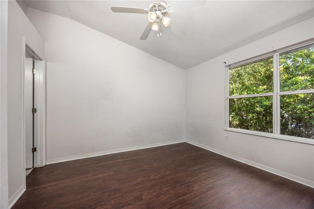 3510 Southwest 30th Way, Unit 158 Gainesville, FL 32608 - Photo 21 of 27 wooden floor in an empty room with a window