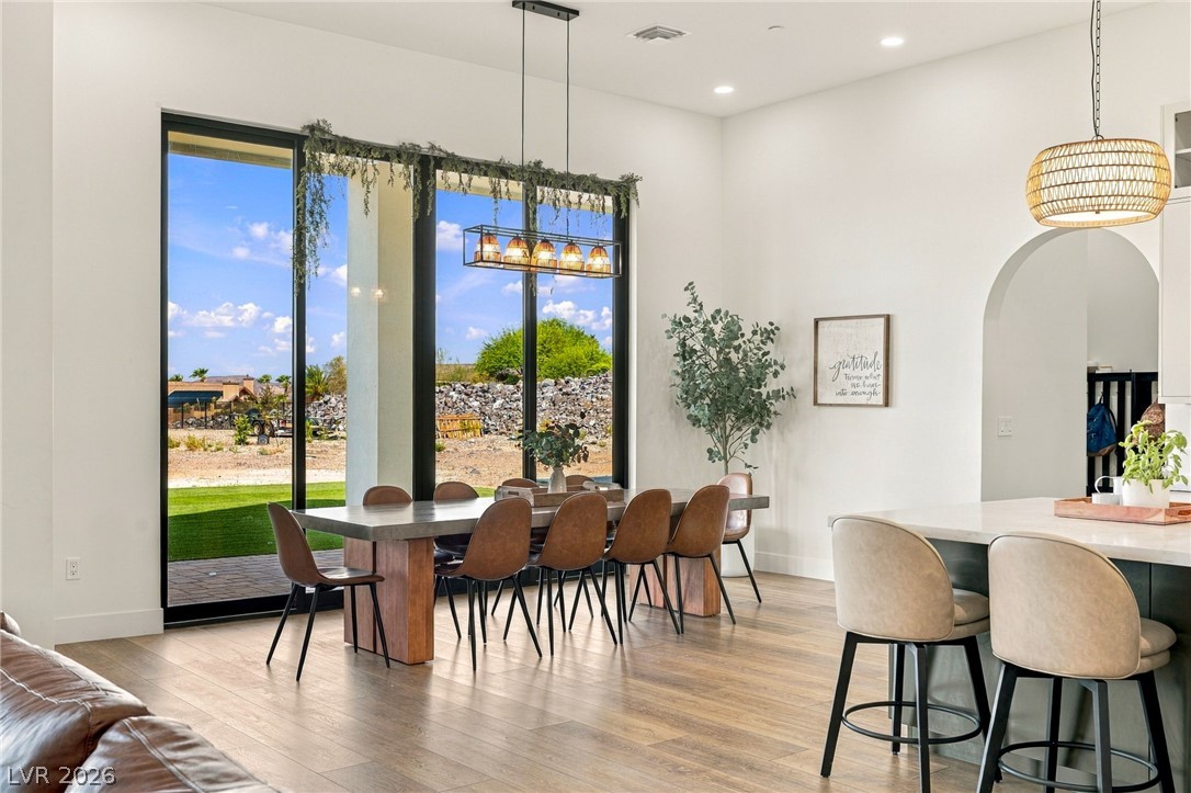 324 Wanda Road Henderson, NV 89002 - Photo 22 of 96 Towering glass doors frame tranquil desert views in this airy dining space.