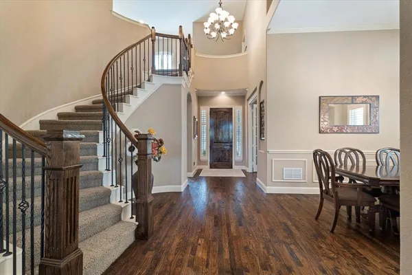 a view of entryway livingroom and hall with wooden floor