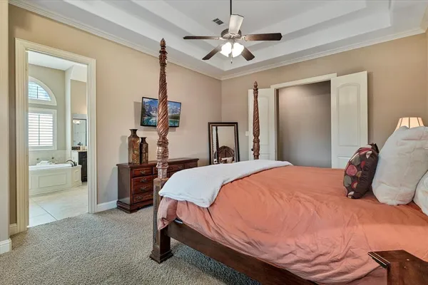 a bedroom with a bed and a chandelier