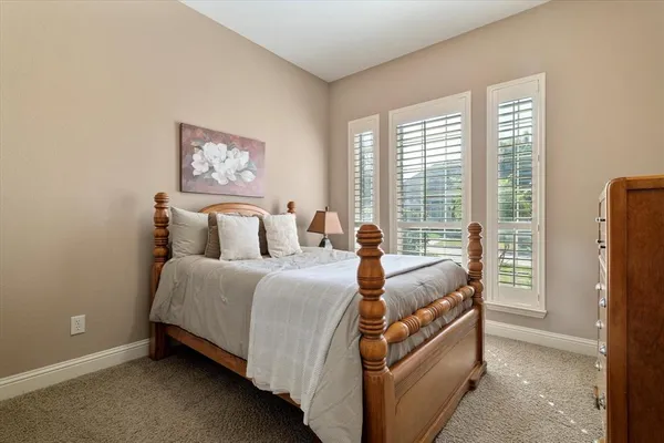 a bed room with a bed and a chair