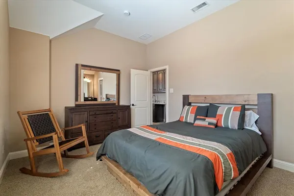 a bedroom with a bed and a chair