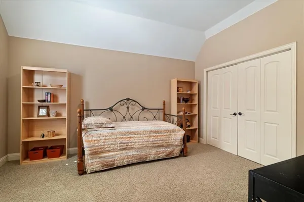 a bedroom with a bed and a closet