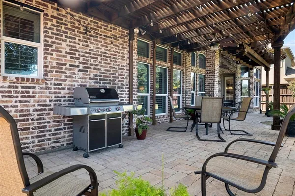 a view of a chairs and table in backyard