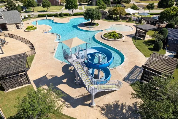 a view of a swimming pool with outdoor seating