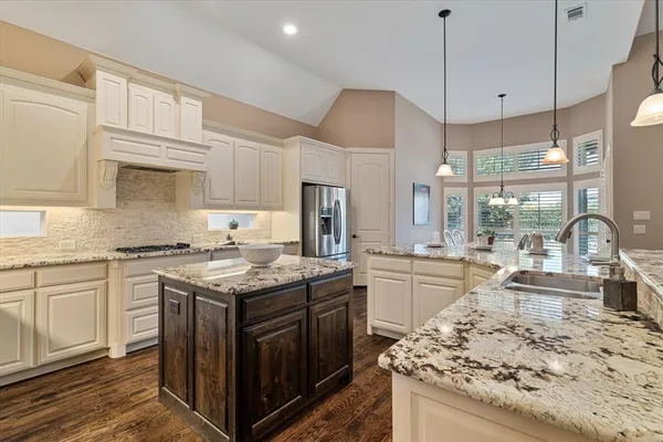 a kitchen with stainless steel appliances granite countertop a stove oven and a view of living room