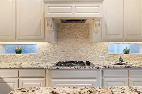 a kitchen with granite countertop cabinets stainless steel appliances and a sink