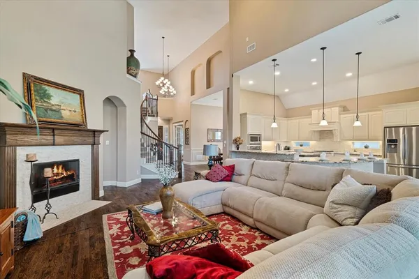 a living room with furniture fireplace and a chandelier